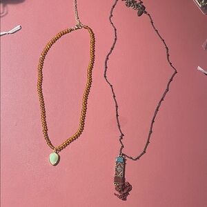 Plunder 2 necklaces gold beads and long black necklace with beads on bottom